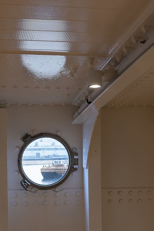 ERCO LED spotlight on the Peking ship, illuminating the interior, seen through a porthole.