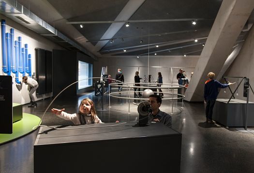 Children interact with exhibits at Phänomenta Science Center, illuminated by ERCO lighting.