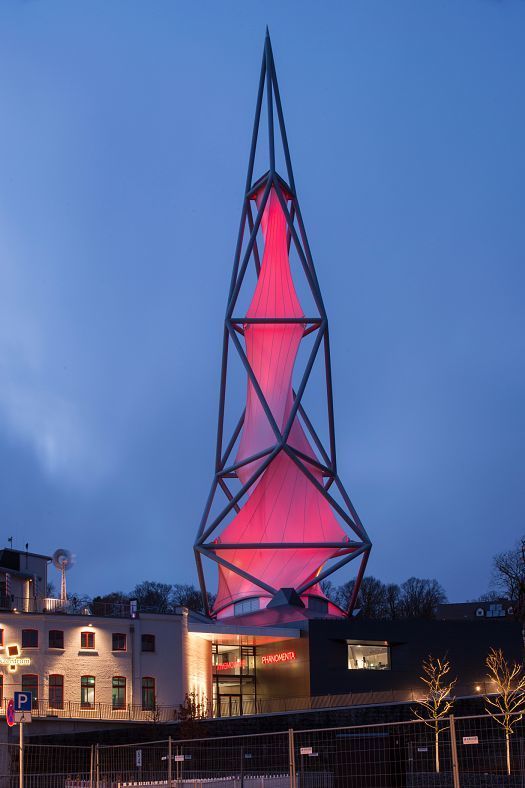 Phänomenta Science Center tower in Lüdenscheid, Germany, featuring red illumination.