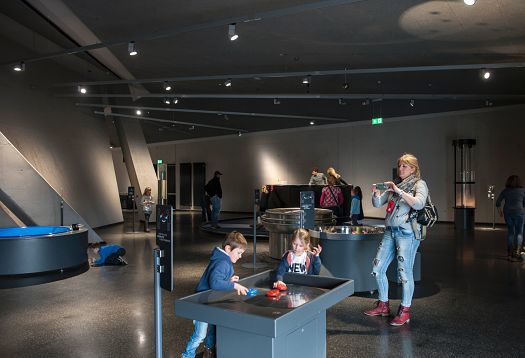 Interactive exhibit at Phänomenta Science Center, illuminated by ERCO lighting.
