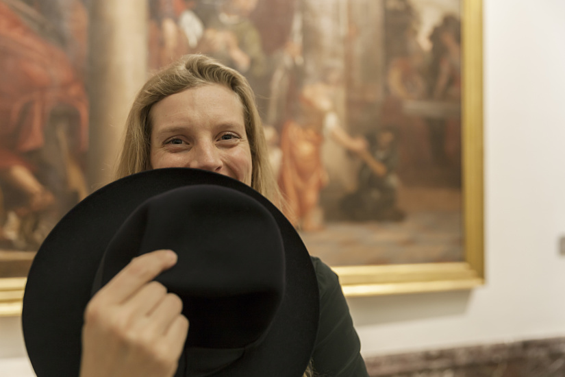 Museum visitor with hat in front of painting at Pinacoteca di Brera, lit by ERCO LED lighting.