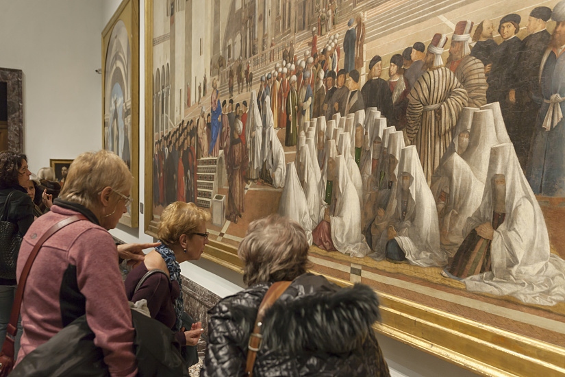 Visitors view a large painting at Pinacoteca di Brera, enhanced by ERCO LED lighting.