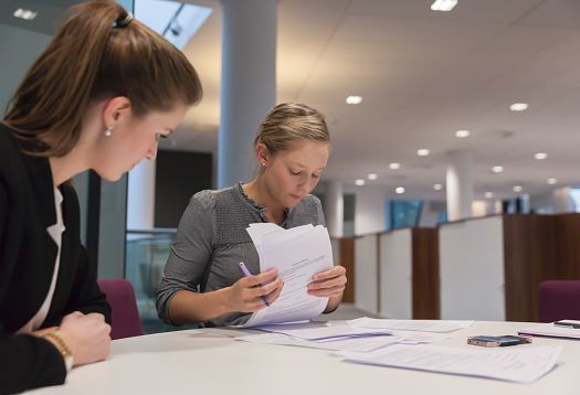 Pinsent Masons office: Lawyers reviewing documents under ERCO office lighting.
