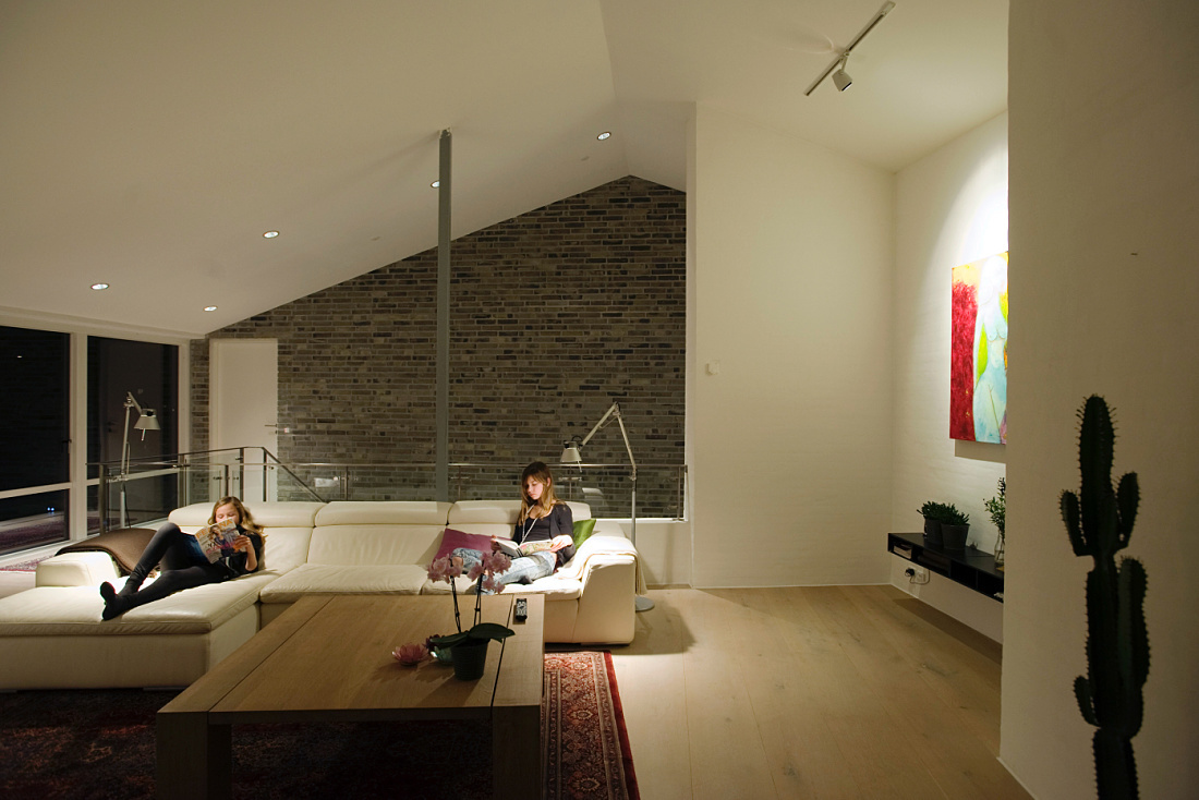 LED light points create a visual connection along the stairs in a Humlebaek residence, enhancing visibility.