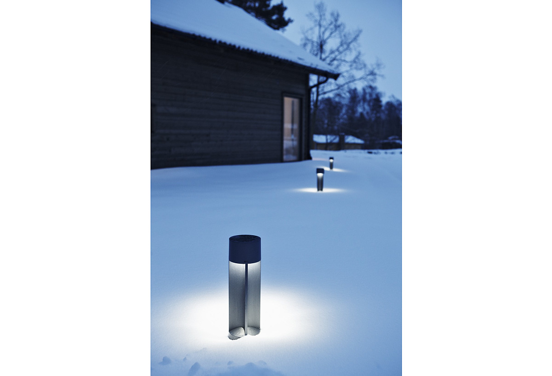 Midipoll bollard lights illuminate a snowy garden path, offering dark sky compliant, glare-free lighting.