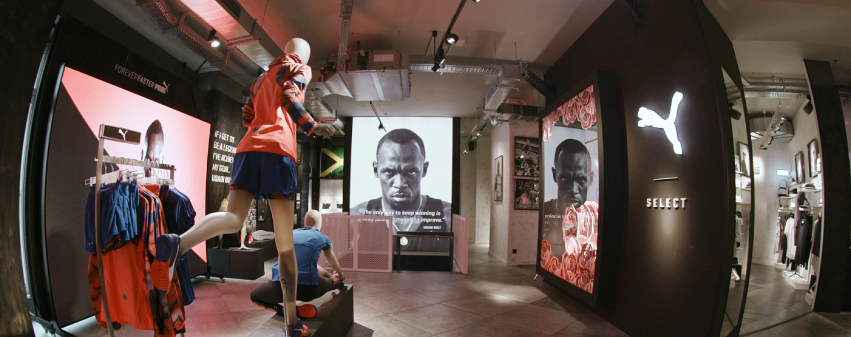 PUMA store in Berlin featuring dynamic sportswear highlighted by ERCO lighting for accents and depth.