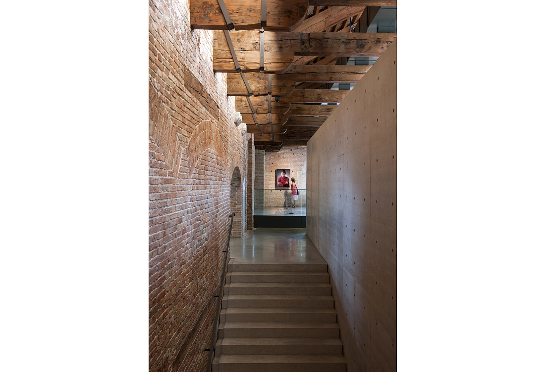 Punta della Dogana interior featuring ERCO lighting and a visitor.