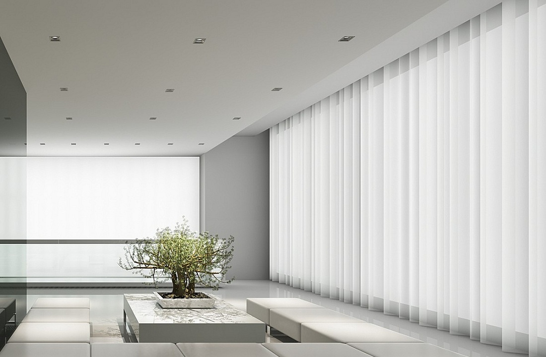 ERCO recessed ceiling luminaires illuminate a minimalist room with curtains and a tree.