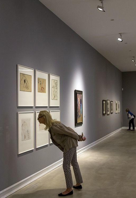 Visitor views art at Ravensburg Art Museum, illuminated by ERCO Optec spotlights.