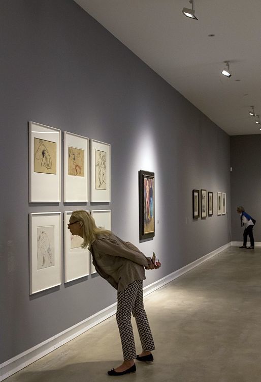 Visitor views art at Ravensburg Art Museum, illuminated by ERCO Optec spotlights.
