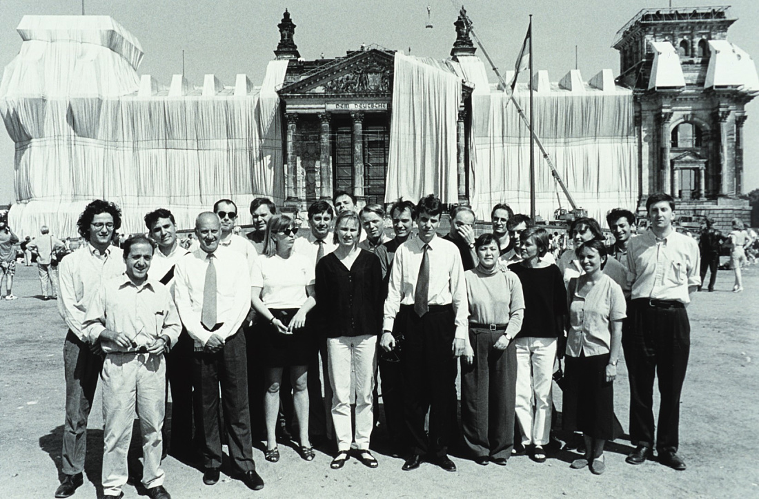 The Wrapped Reichstag in Berlin with a group of people in front.