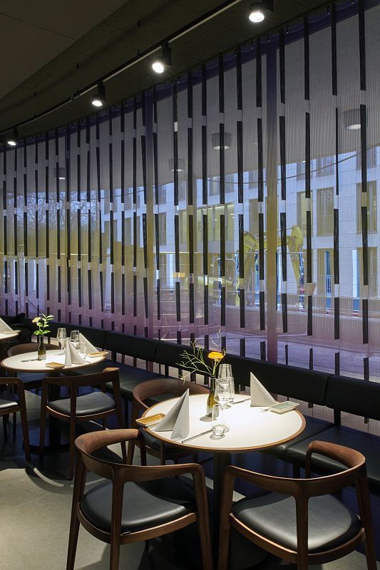 Restaurant at Schauspielhaus Dusseldorf with ERCO LED lighting and set tables.
