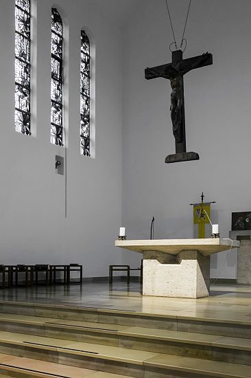 Interior of St. Mary's Birth Church featuring ERCO spotlights highlighting the altar and crucifix.