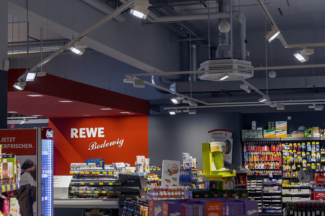 Opton LED spotlights in REWE supermarket for energy-efficient accent lighting.