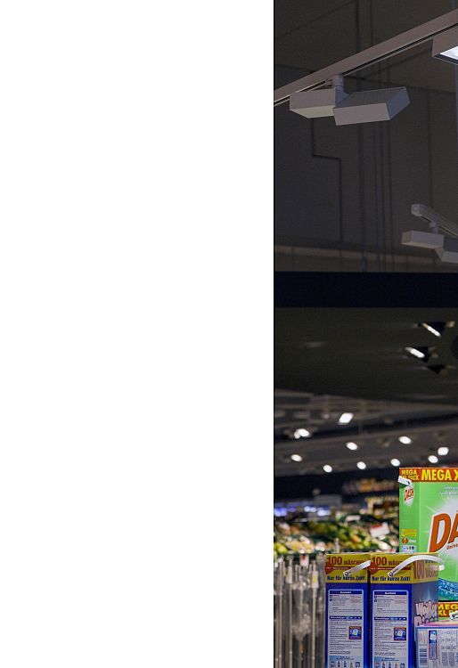 ERCO Opton LED spotlights accent Dash detergent in REWE Hohenlimburg, energy-efficient and precise.