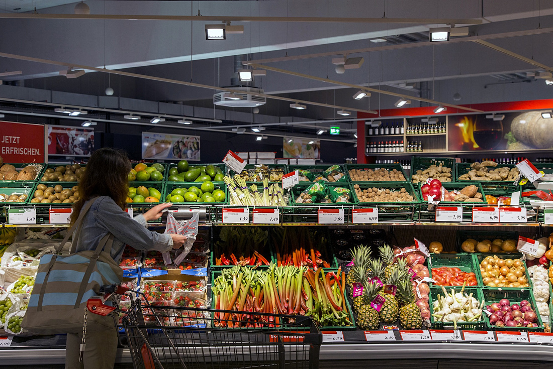 REWE supermarket produce section featuring Opton LED accent lighting for fresh products.