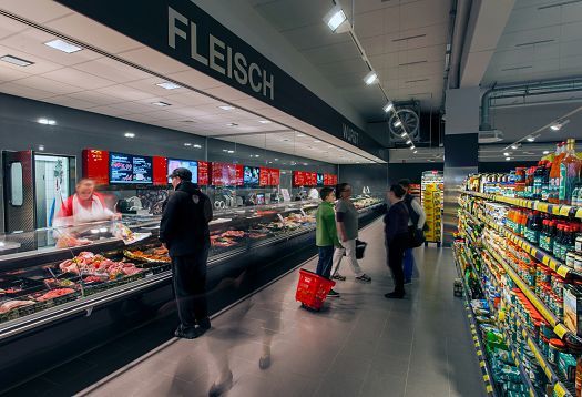 REWE supermarket in Hagen-Hohenlimburg featuring ERCO LED lighting in the meat section.