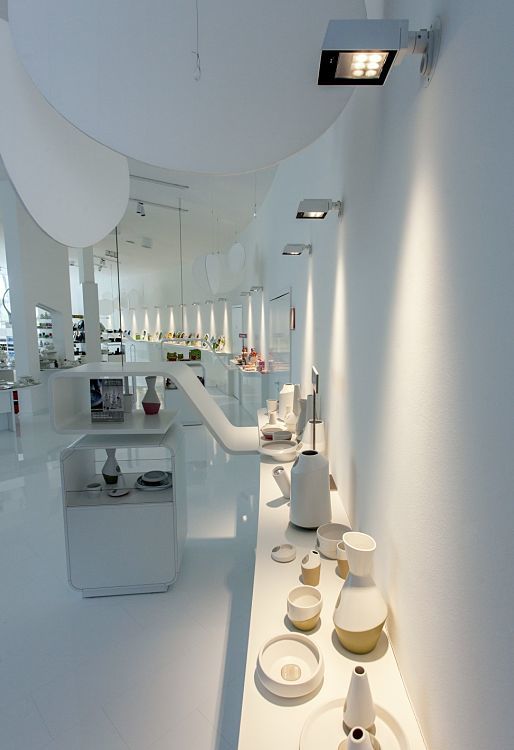 Ritzenhoff glass factory showroom illuminated by ERCO Light Board spotlights, accenting displayed glassware.