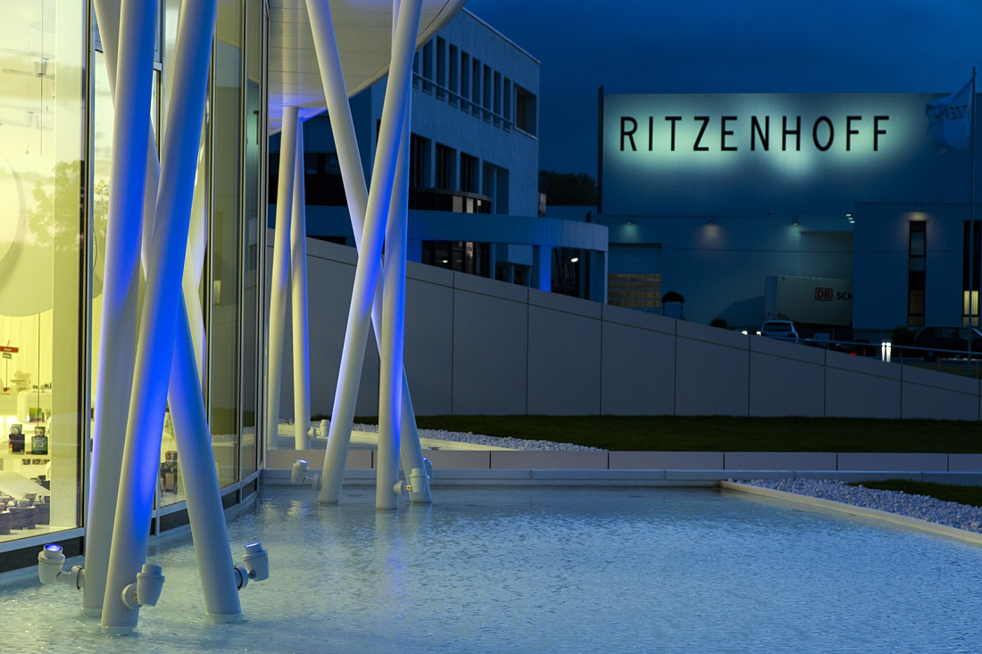 Illuminated Ritzenhoff glass factory featuring ERCO lighting solutions outdoors.