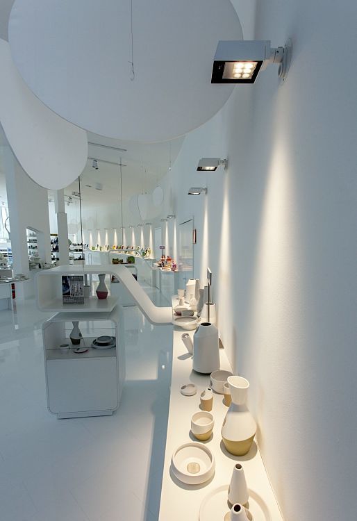 Ritzenhoff glass factory showroom illuminated by ERCO Light Board spotlights, accenting displayed glassware.