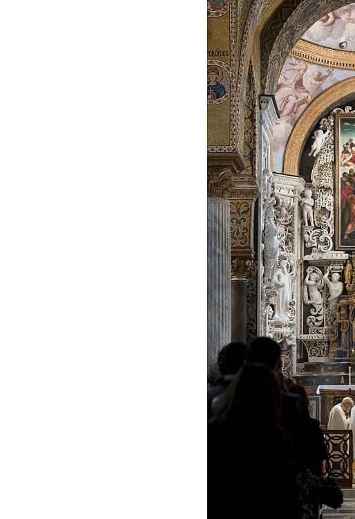 Interior of Santa Maria dell’Ammiraglio church in Palermo, showcasing ornate ceilings and a religious ceremony.