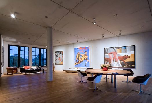 ERCO LED spotlights illuminate art in a Berlin residence with an open living space and dining table.