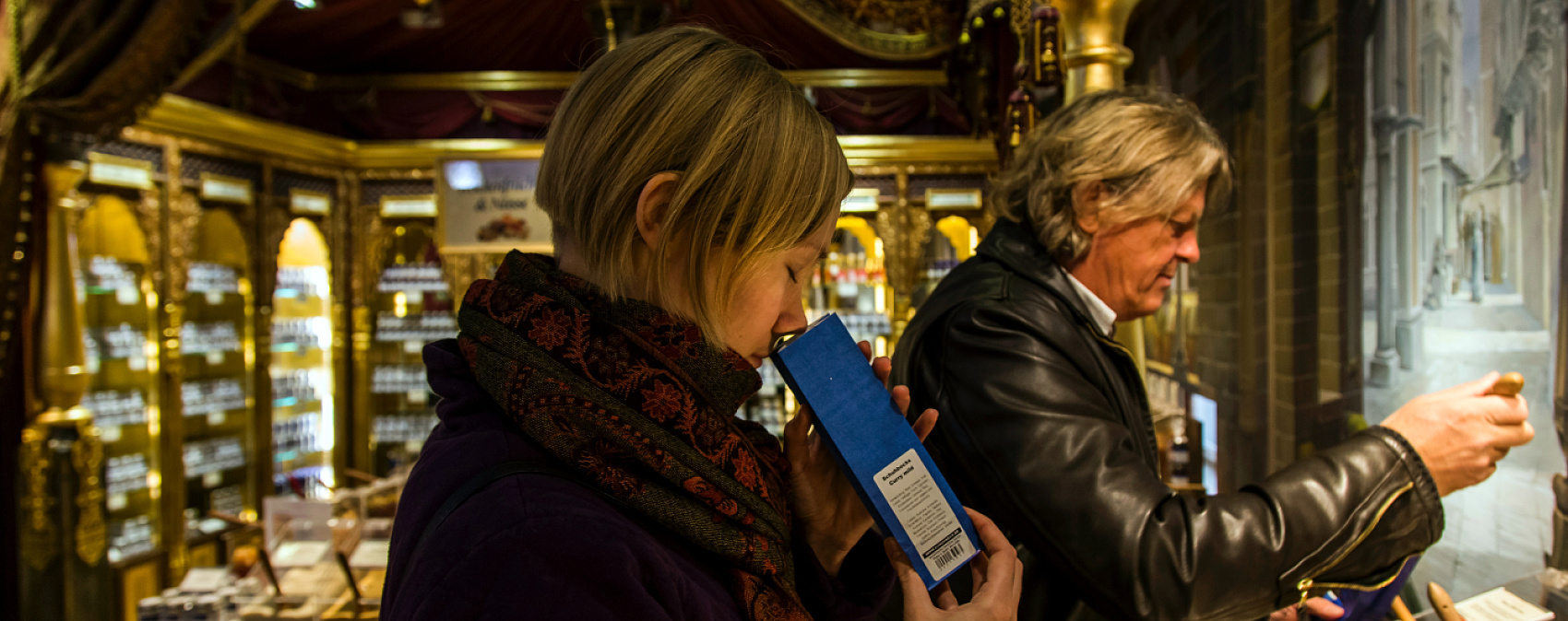 Customer smelling spices in Schuhbeck's spice shop, Munich, lit by ERCO LEDs.