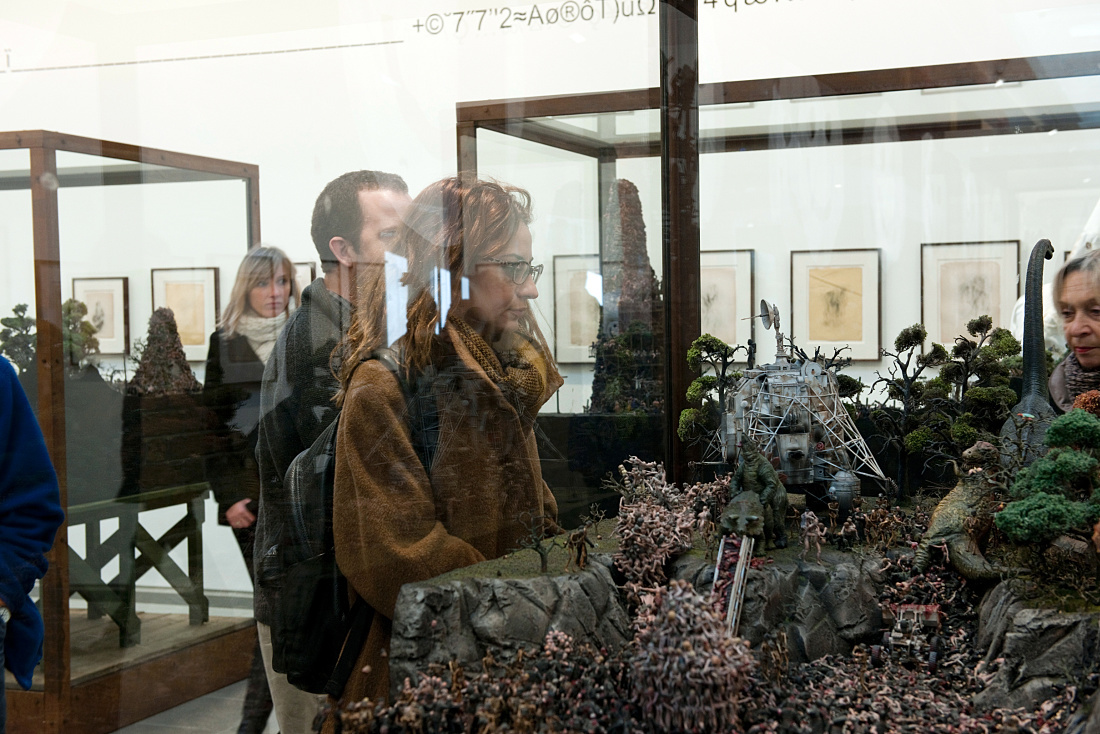 Visitors view an installation by Jake and Dinos Chapman at the Serpentine Sackler Gallery, lit by ERCO lighting.