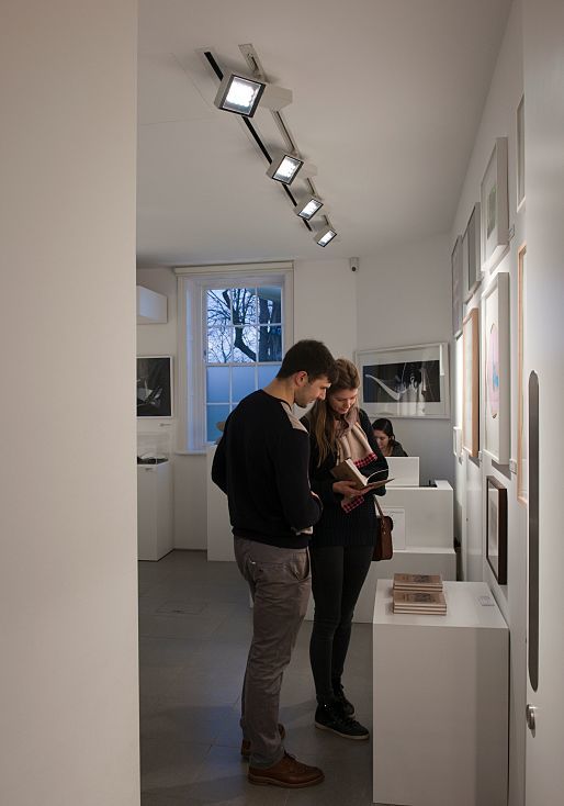 Visitors view art illuminated by ERCO Opton spotlights in the Serpentine Sackler Gallery.