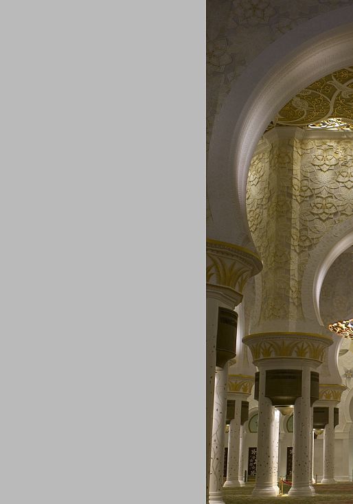 Interior of Sheikh Zayed Mosque featuring decorative lighting and ornate archways.