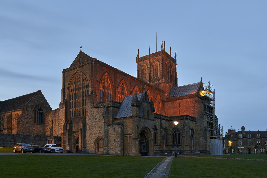 Sherborne Abbey illuminated by ERCO LED lighting at dusk.