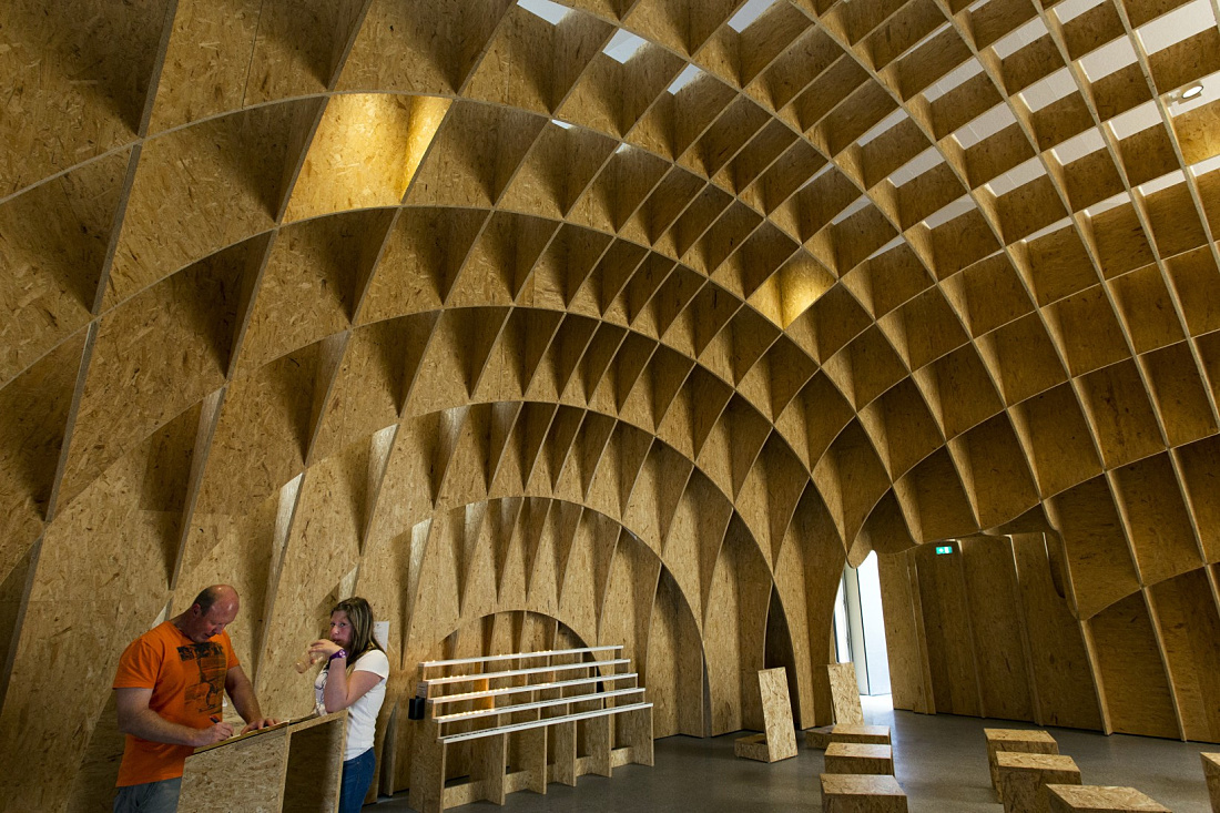 Interior of Siegerland Motorway Church featuring wooden structure and lighting.