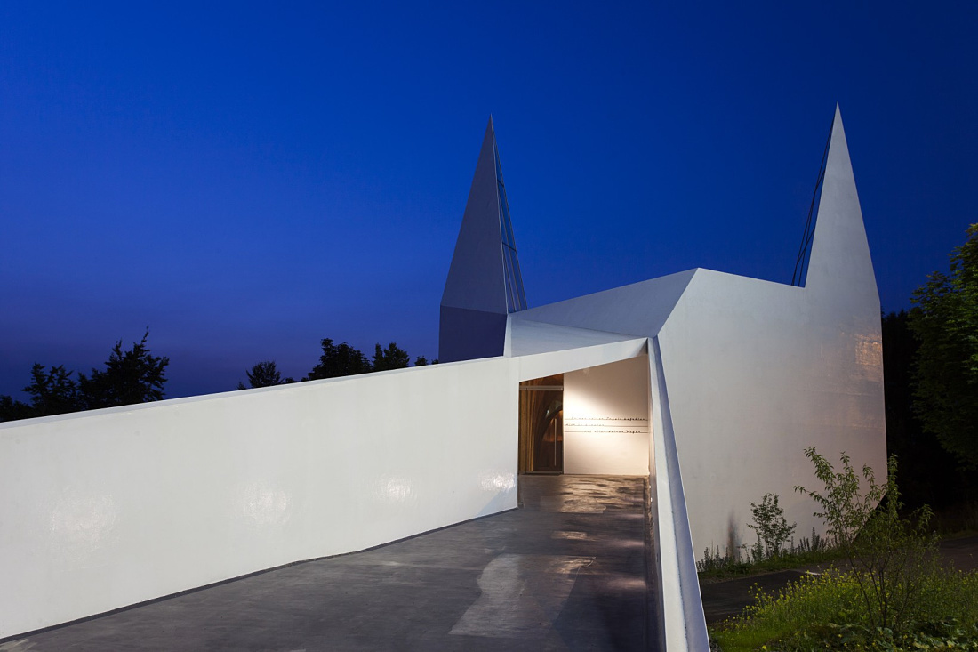 Siegerland Motorway Church, Wilnsdorf: Bright, polygonal facade with LED lighting for contemplation.