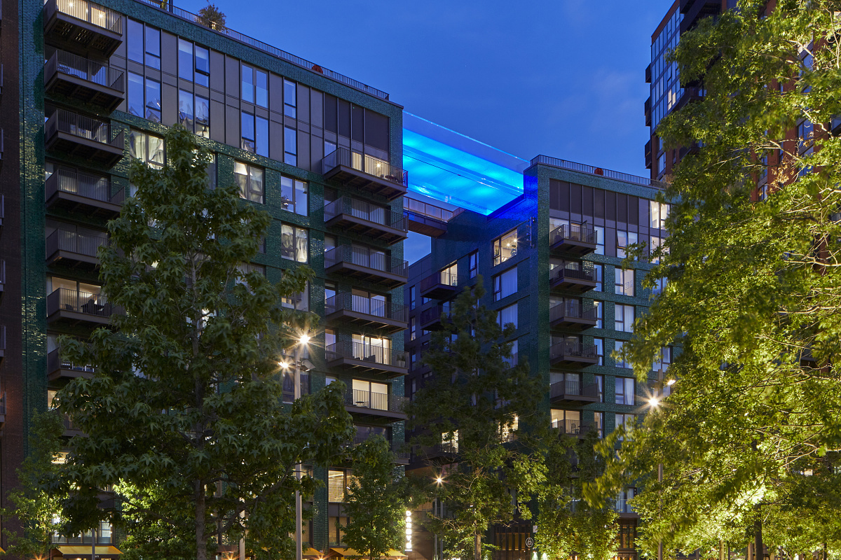 Sky Pool at Embassy Gardens, London, illuminated by ERCO Kona projectors with blue LEDs for atmospheric outdoor lighting.