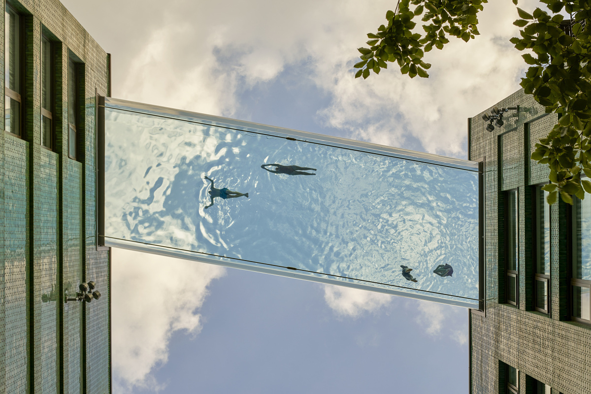 Sky Pool at Embassy Gardens, London: Swimmers enjoy the lofty height, lit by ERCO Kona projectors.