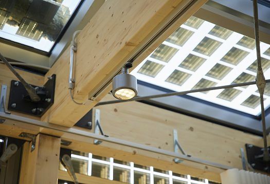ERCO Parscan spotlight on wooden beams, providing sustainable lighting for Solar Decathlon project.