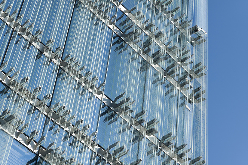 SPG Headquarters Geneva facade with ERCO LED lighting illuminating a second skin of glass lamellae.