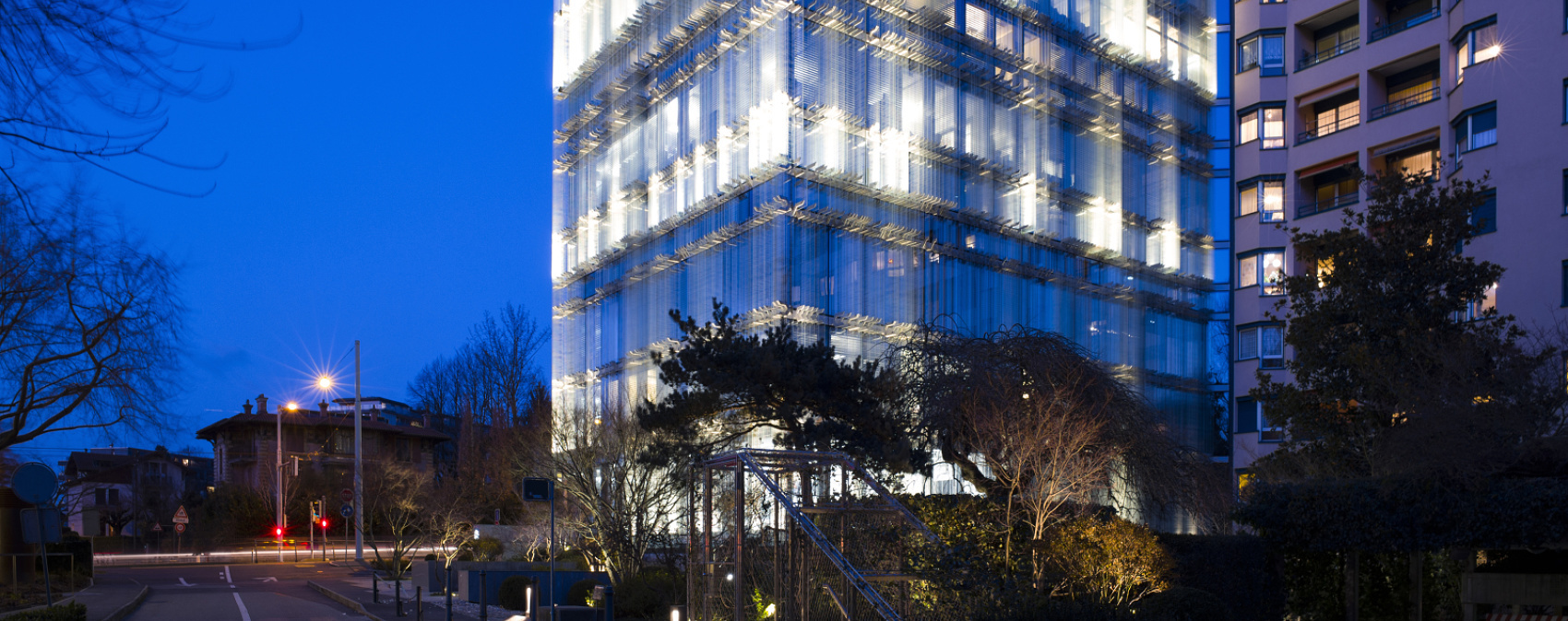 SPG Headquarters Geneva illuminated at night with ERCO LED facade lighting.