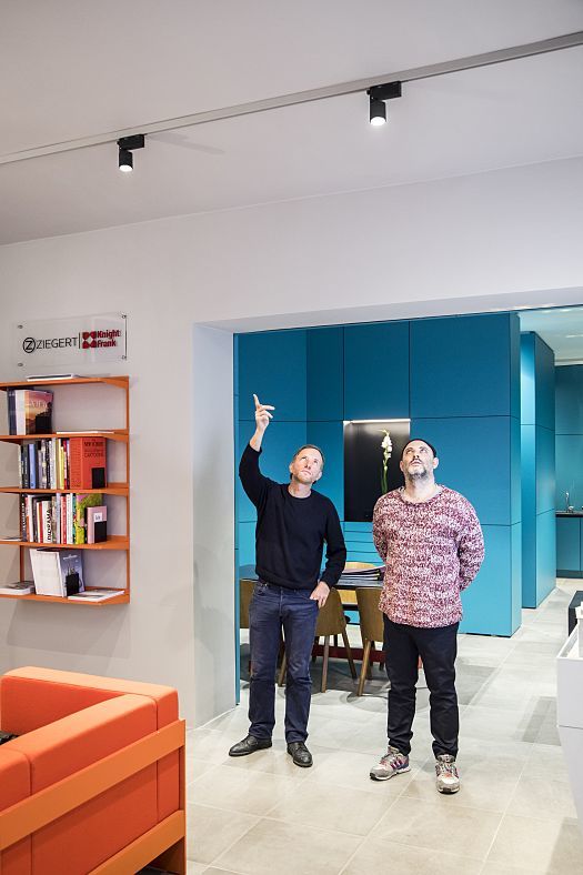 ERCO Pollux spotlights in ZIEGERT Knight Frank shop, Frankfurt, with design team planning lighting.