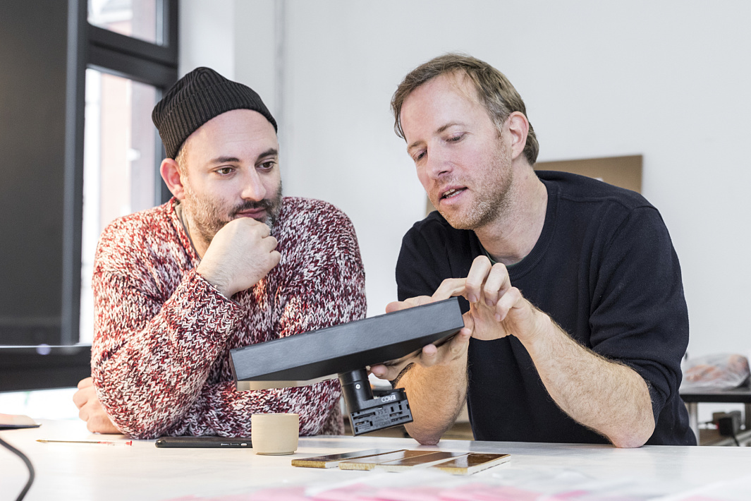 Designers Paul Bauer and Oskar Melzer with ERCO Pollux spotlight in Frankfurt showroom.