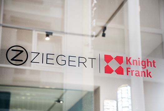 ZIEGERT Knight Frank logo on glass, a Frankfurt real estate shop featuring ERCO lighting.