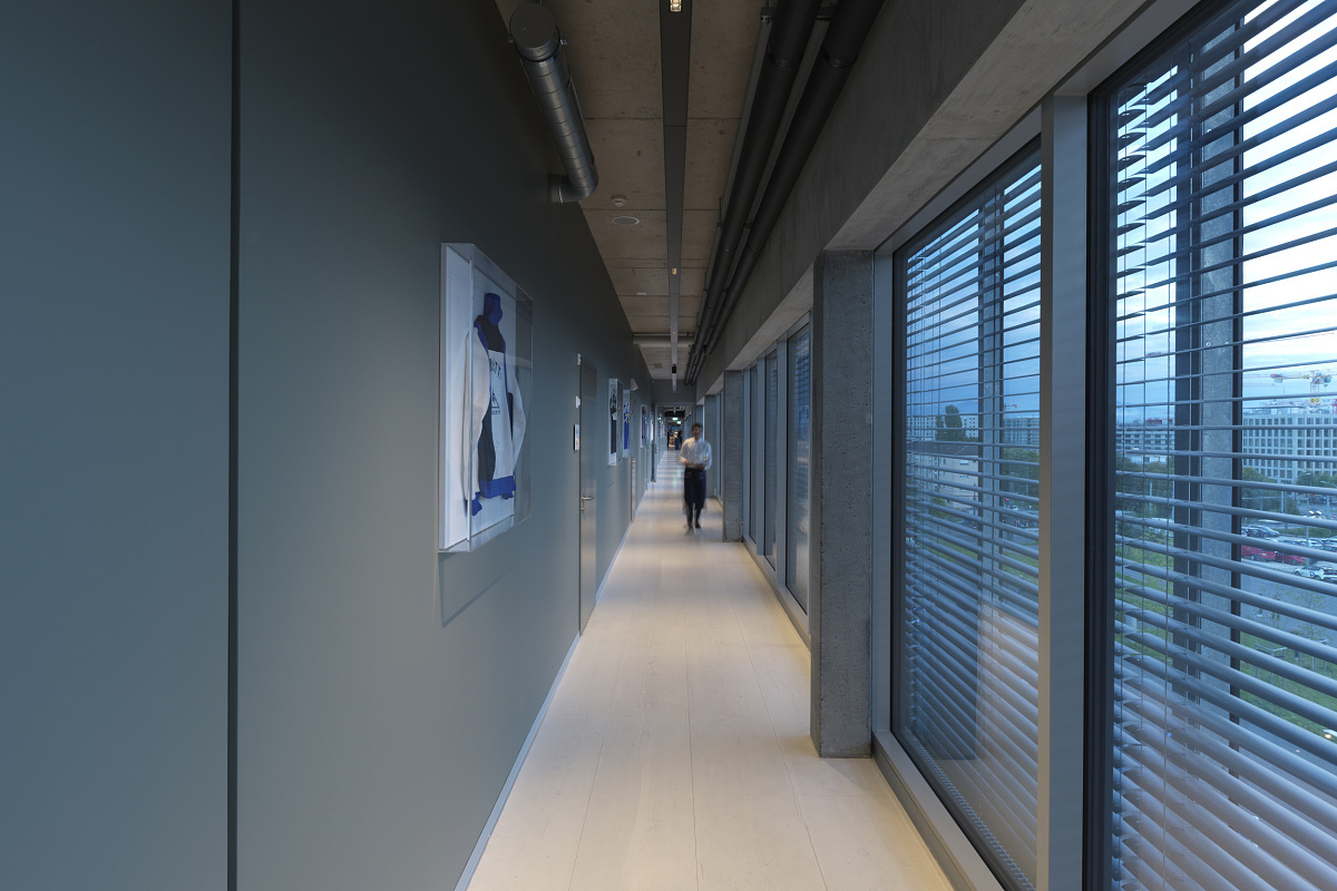Hallway in Stade de la Tuilière featuring ERCO LED downlights for glare-free lighting and visual comfort.