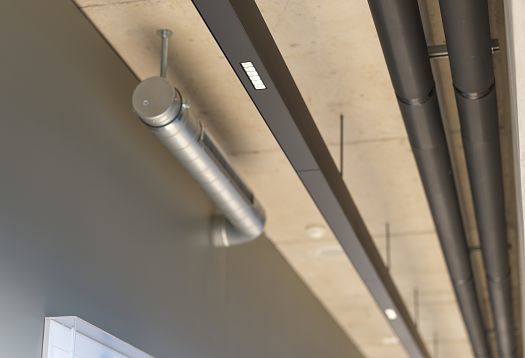 ERCO Compar linear LED downlights in a stadium, providing glare-free light for visual comfort.