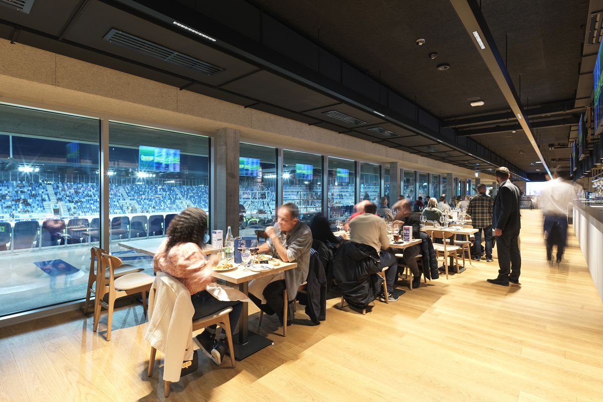 ERCO LED lighting in Stade de la Tuilière, Lausanne. Glare-free lighting ensures visual comfort in the VIP areas overlooking the pitch.