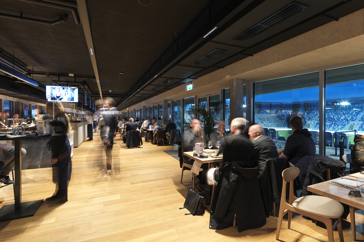 ERCO LED lighting in the VIP area of Stade de la Tuilière, Lausanne, ensuring visual comfort.