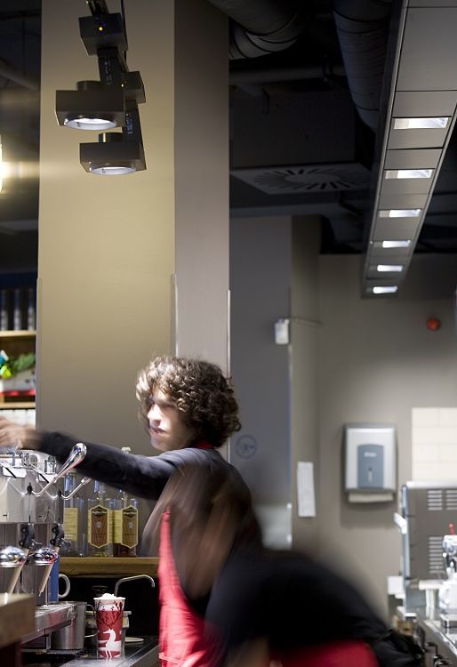 ERCO LED spotlights and wallwashers in a Starbucks at Altmarkt, providing efficient visual comfort and sustainability.