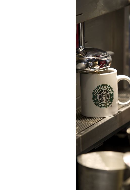 Starbucks mug under LED lighting in a sustainable cafe.