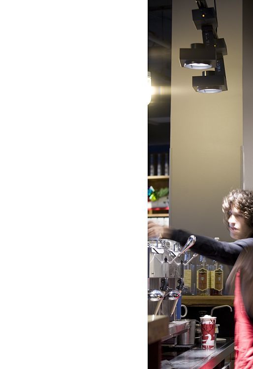 ERCO LED spotlights and wallwashers in a Starbucks at Altmarkt, providing efficient visual comfort and sustainability.