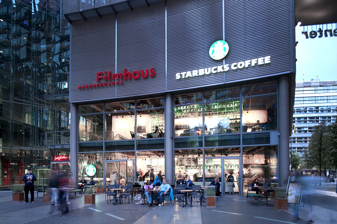 Starbucks Coffee House in Berlin, featuring inviting lighting and outdoor seating.