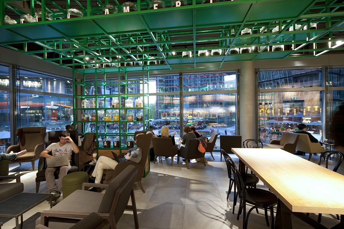 Starbucks Coffee House in Berlin featuring ERCO LED lighting for a welcoming ambiance.